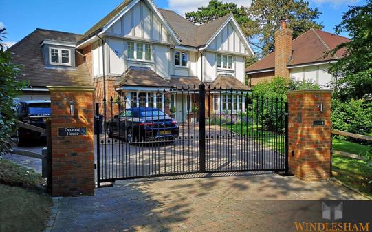 Metal Driveway Gates with Brick Piers and House Sign